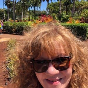 image of Leigh Anne smiling with land in the background