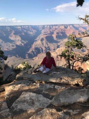 image of leigh anne sitting on rock with mountains in the background