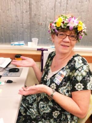 image of Leigh Anne wearing flower crown and sitting at her desk