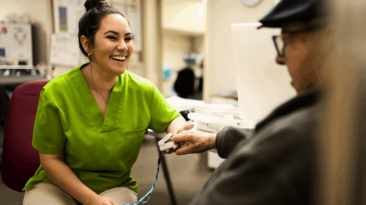 clinician-in-green-scrubs-helping-patient