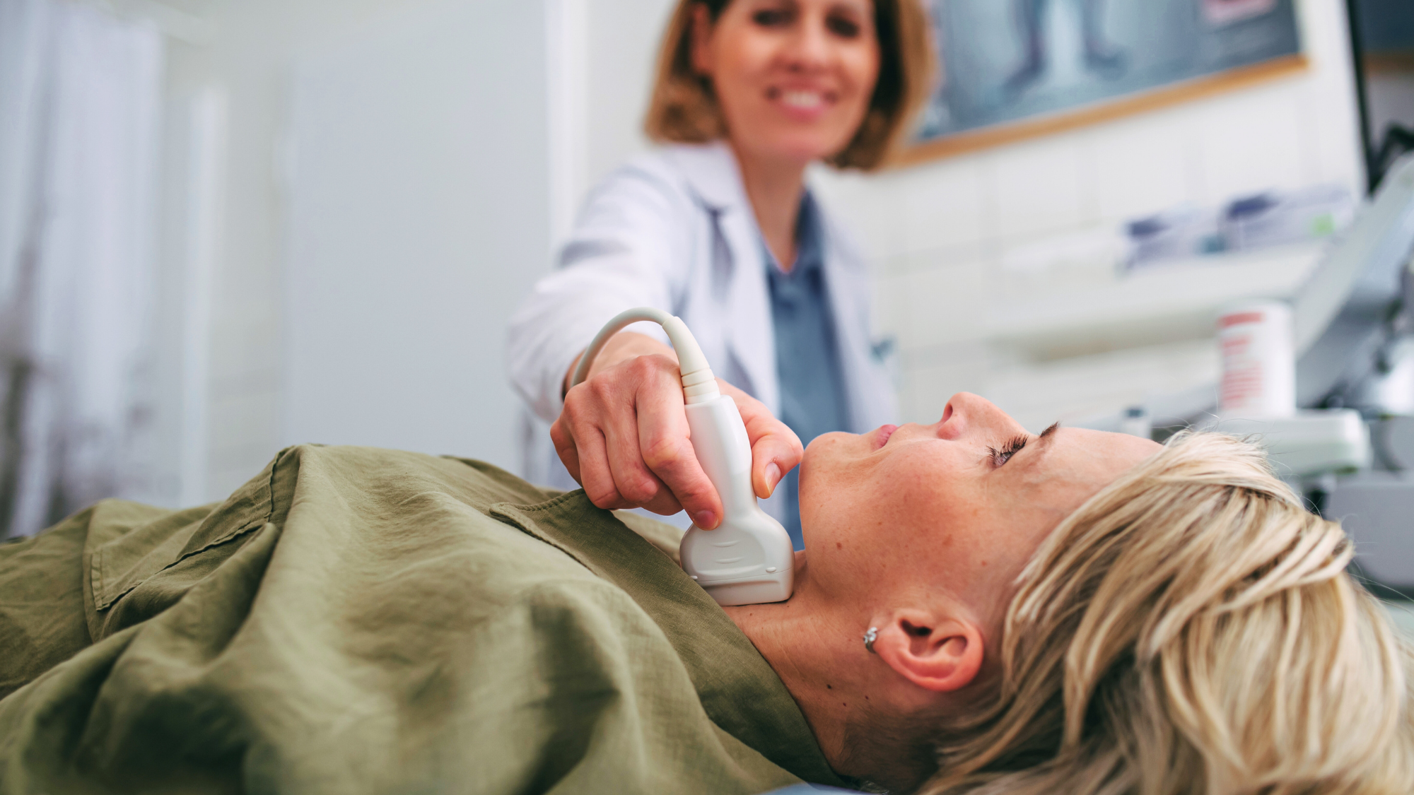 Imaging tech scanning a patient's neck
