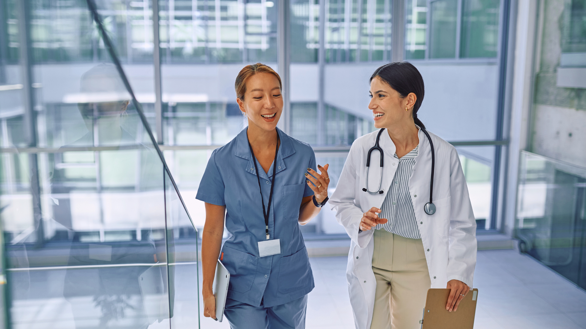 A female doctor and female nurse walking together