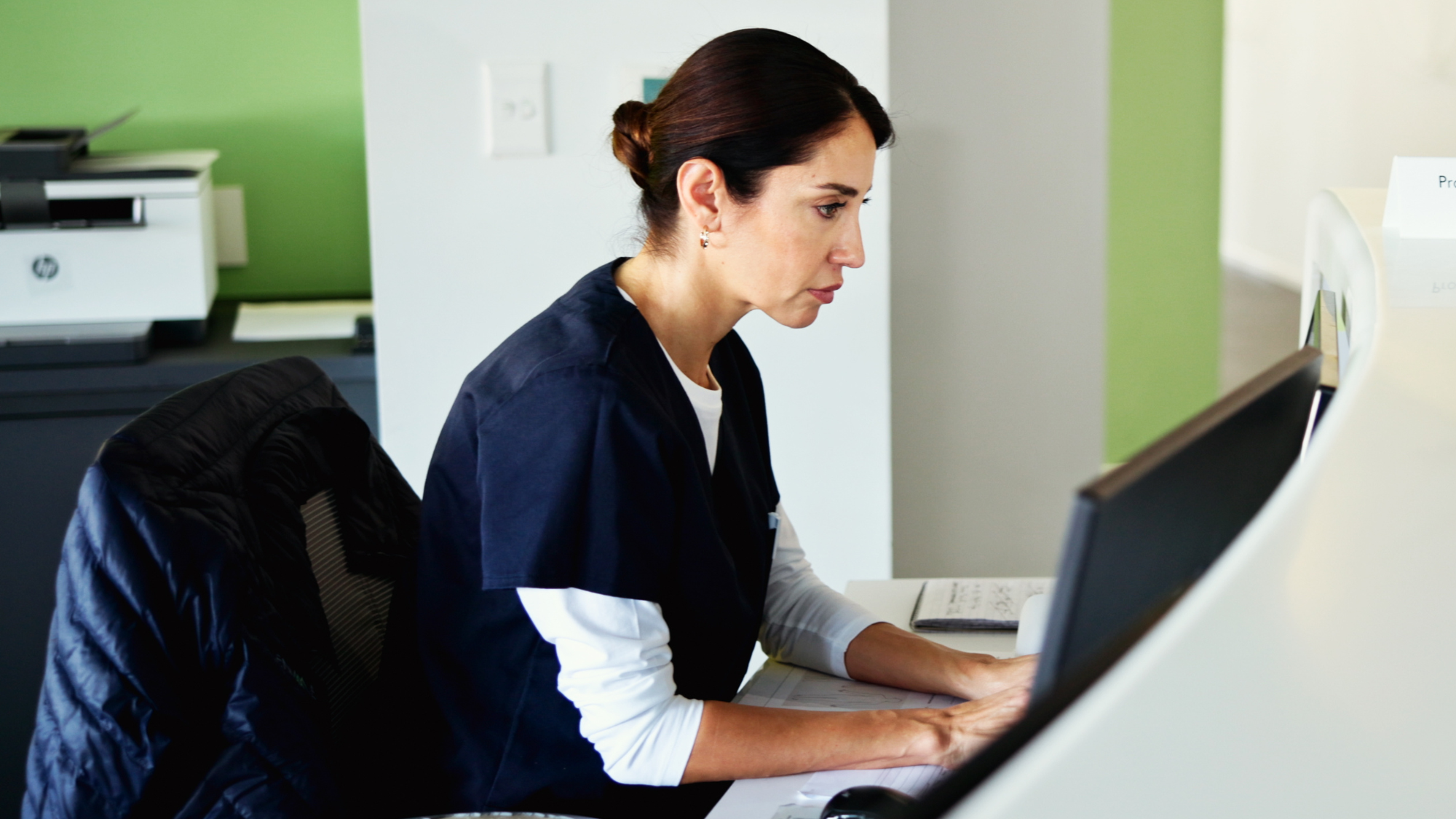 Female nurse typing on a computer