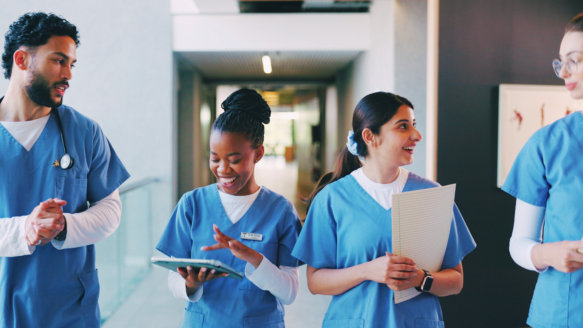 Two female nurses walking in the hallway together