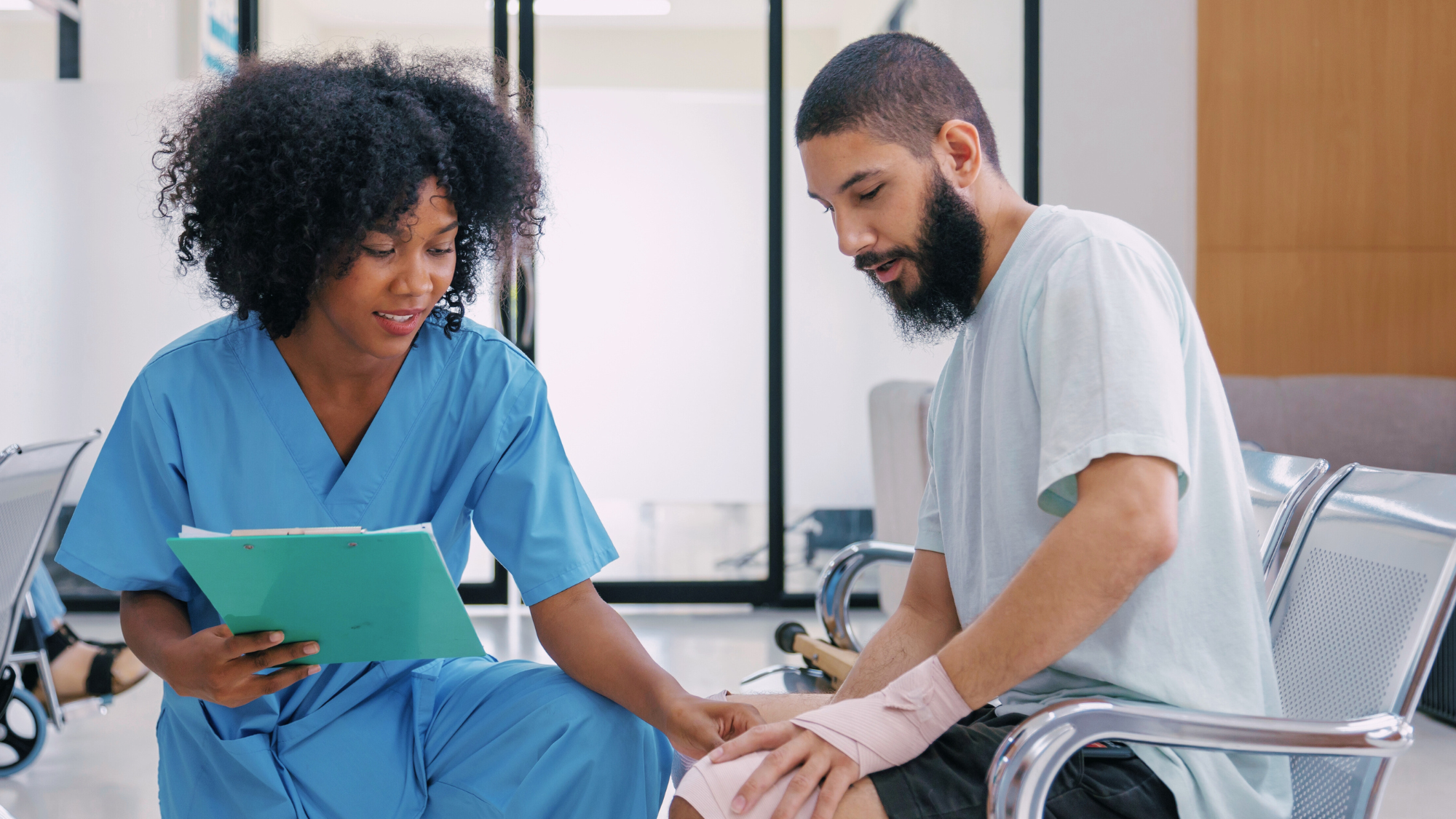 A female nurse helping a male patient