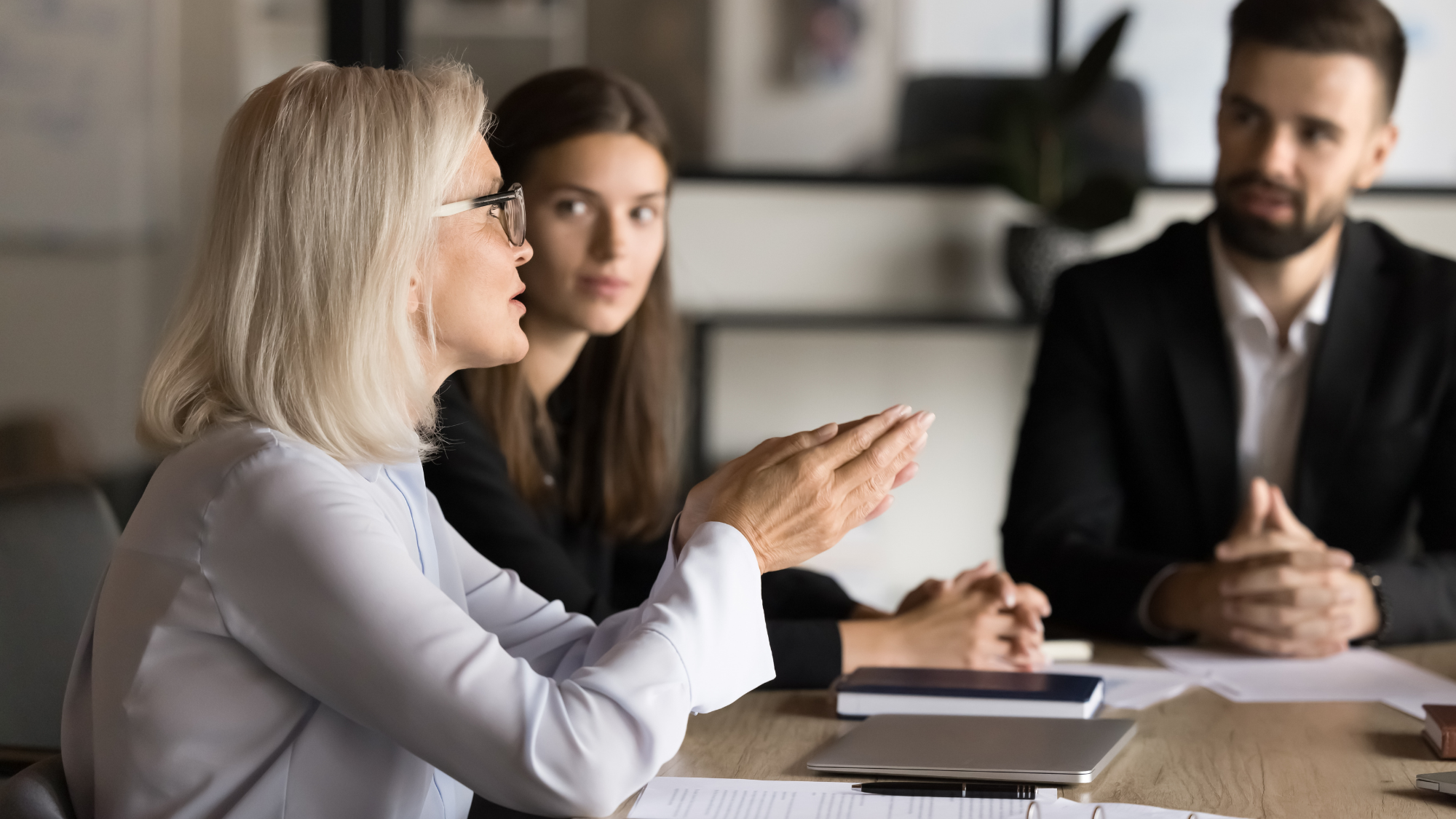 Boardroom discussion between workforce partner and clients