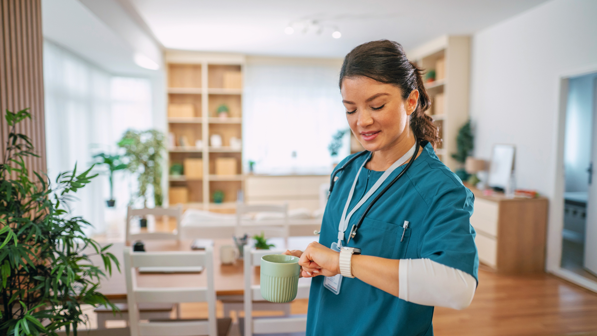 Female clinician with brown hair looking at her watch