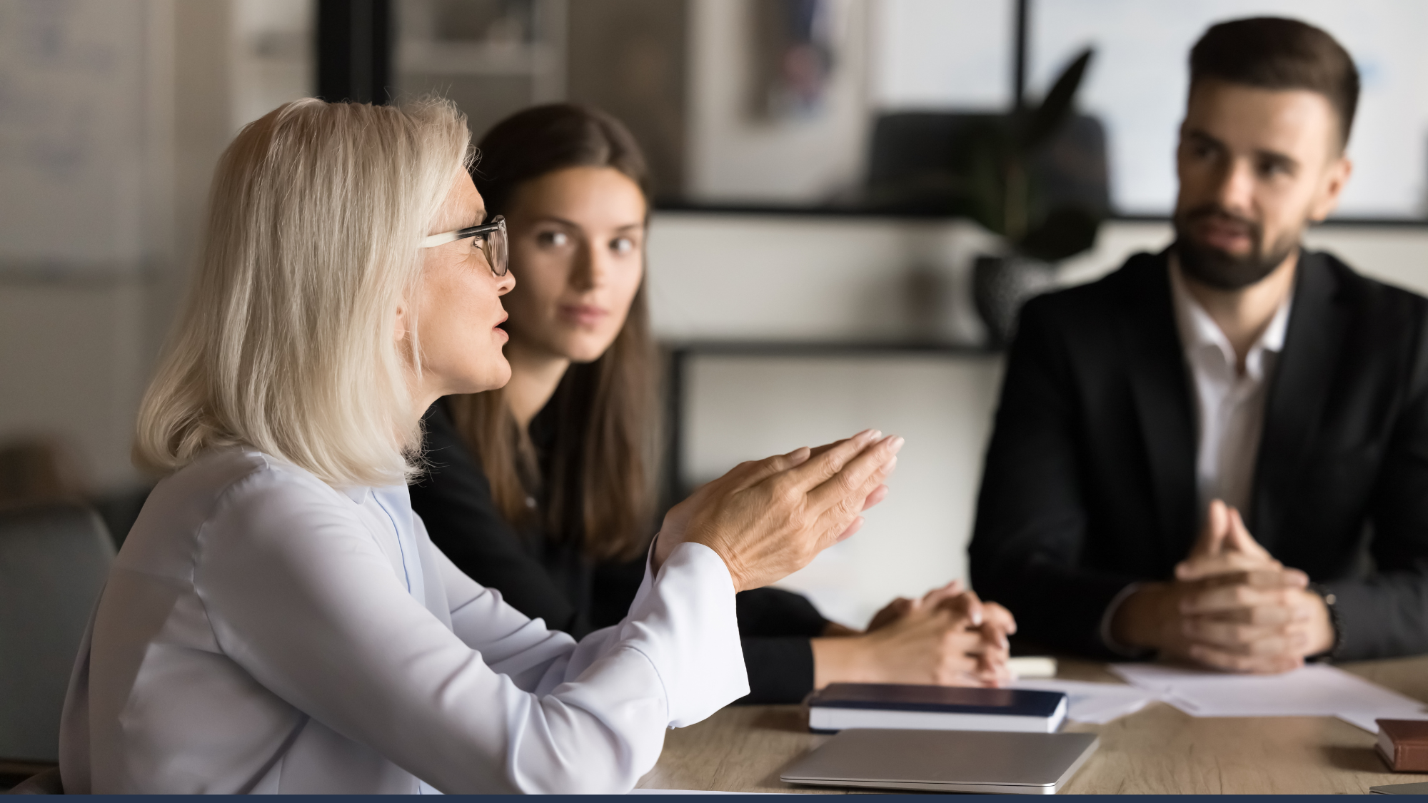 Health executives and workforce partners discussing staffing strategy in a meeting room
