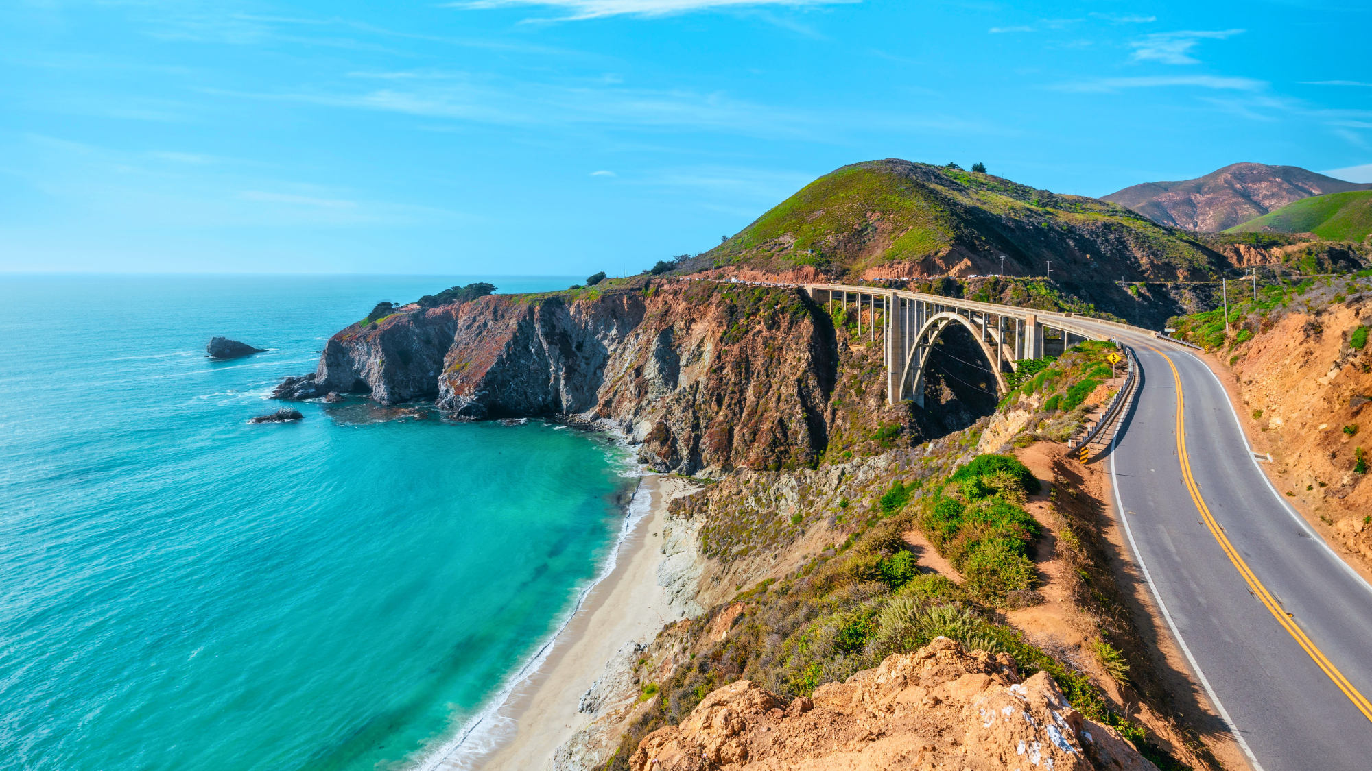 Aerial view of cliff, beach, and ocean in California.